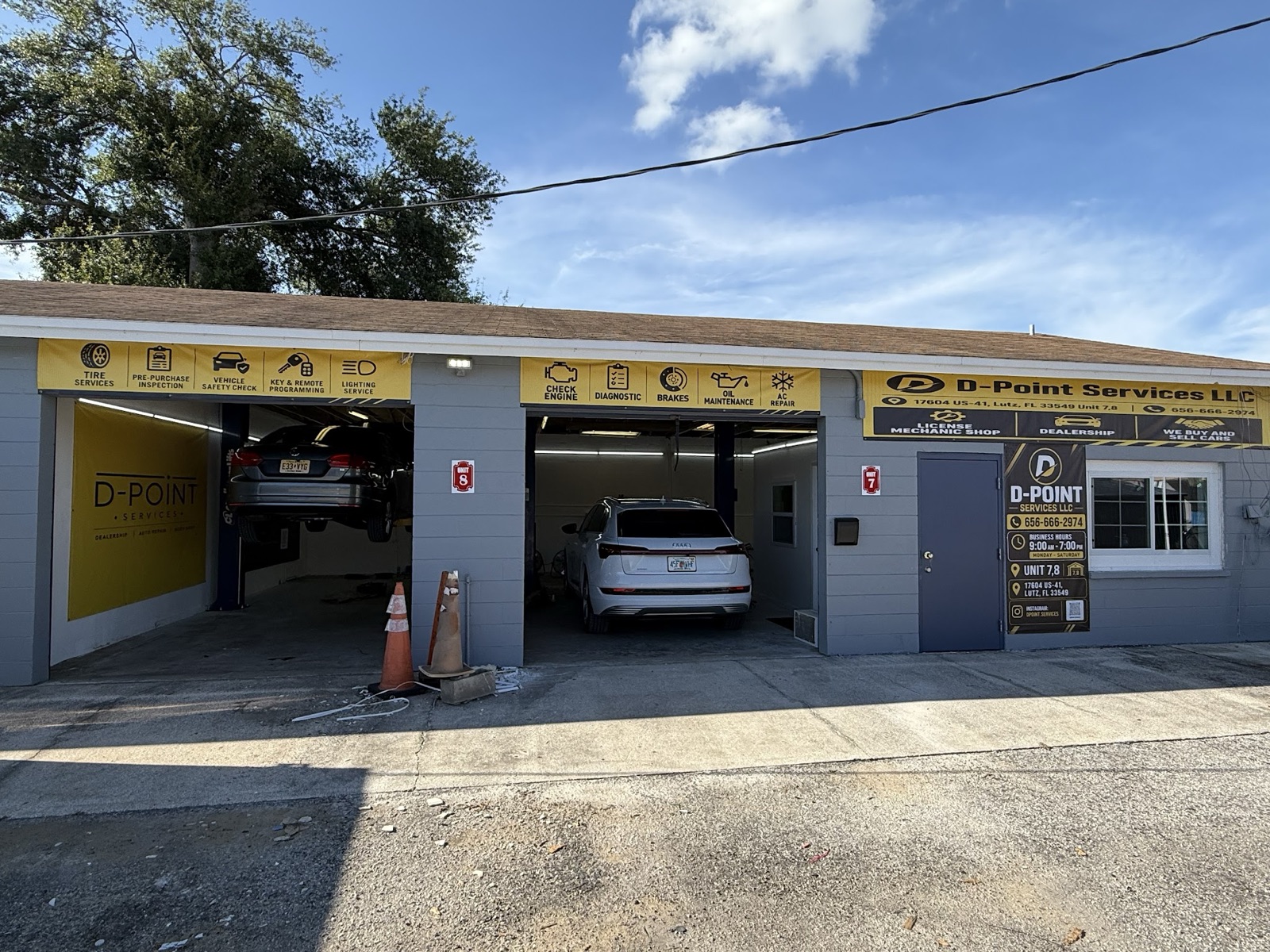 D-Point Services shop on US-41 in Lutz: two open bays, service banners and the office door