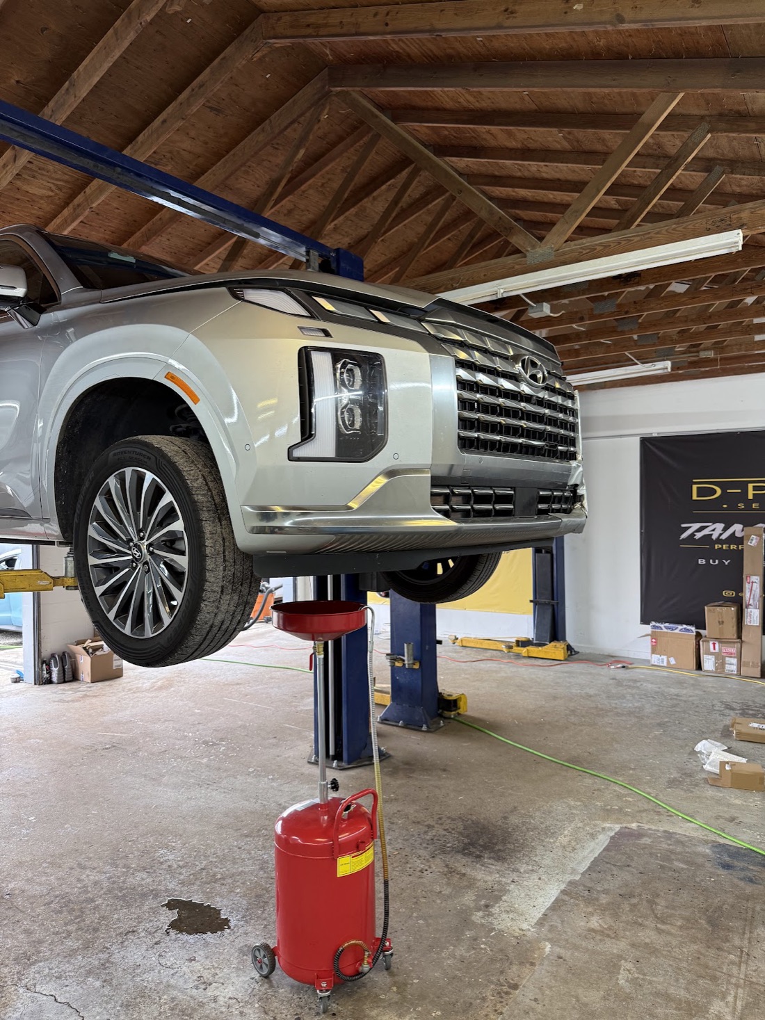 SUV raised on the lift inside the D-Point shop